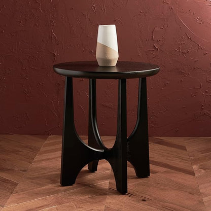 SAFAVIEH Sasha Accent Table with black oak veneer in a modern living room, holding a decorative piece