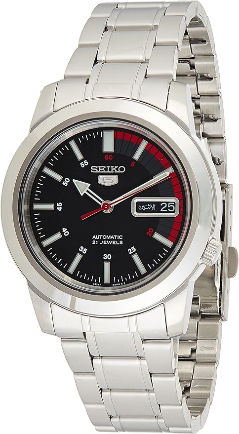 ose-up of the Seiko SNKK31 watch face, highlighting the black dial, luminous hands and markers, and day/date display